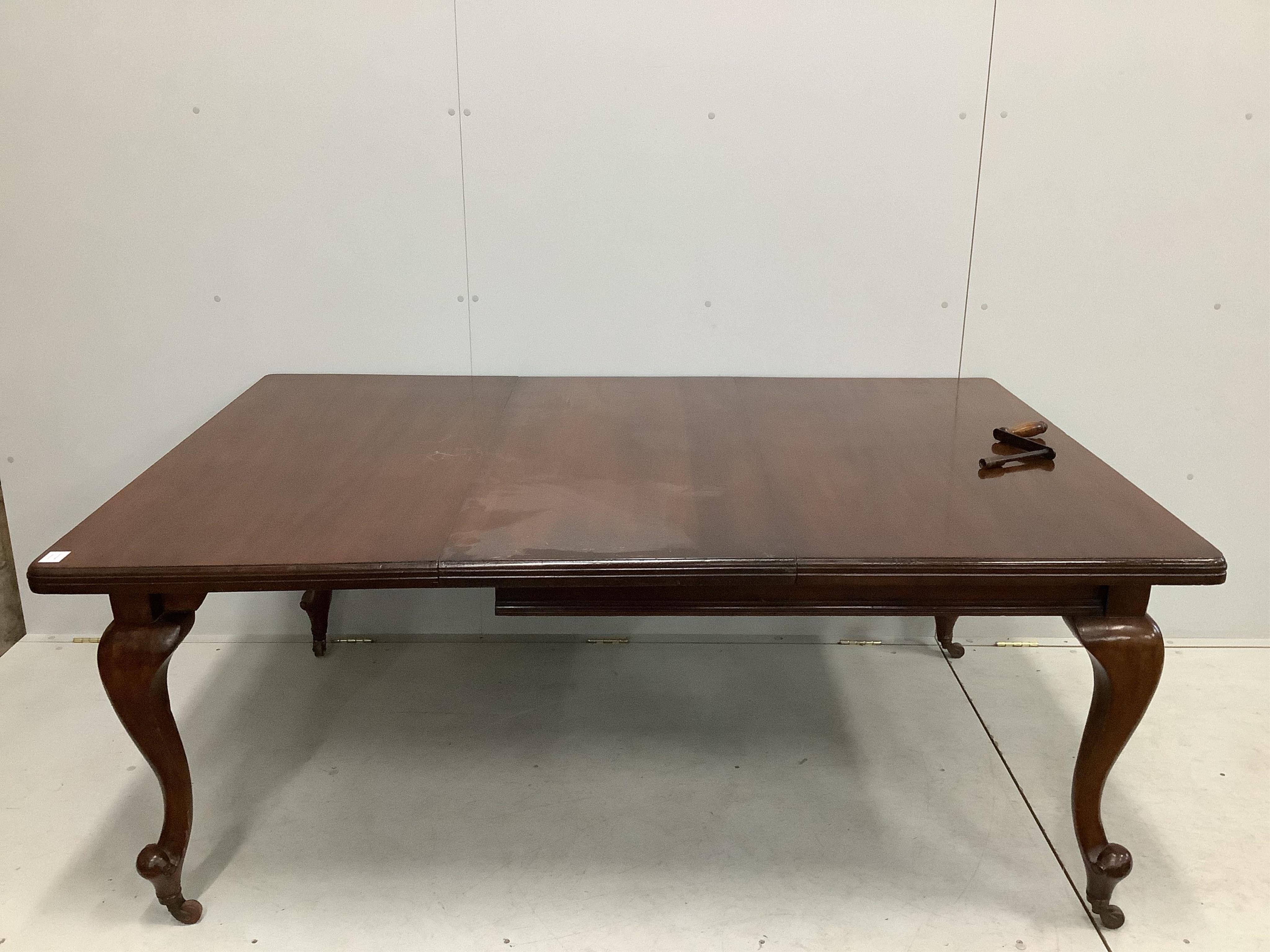 An early 20th century mahogany extending dining table, with one spare leaf and winder, 180cm extended, depth 120cm, height 71cm. Condition - fair to good